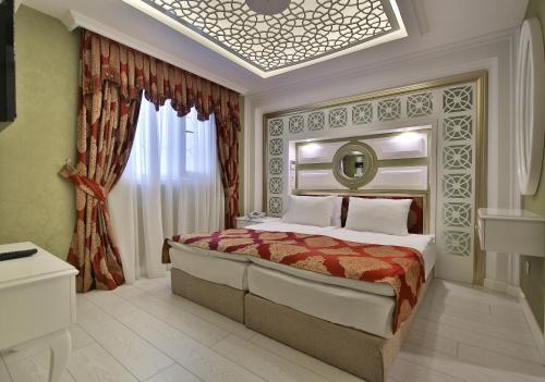 a bedroom with a large bed in a room at Hotel Queens Land in Istanbul