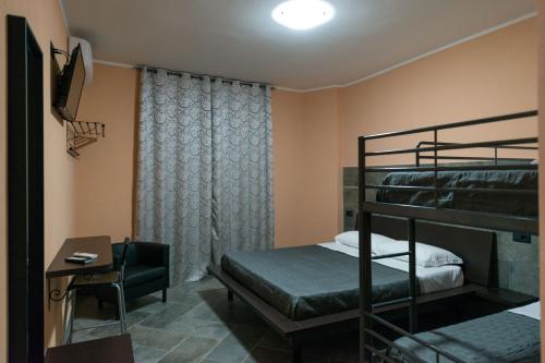 een slaapkamer met 2 stapelbedden en een bureau bij B&B Mazzini in Battipaglia