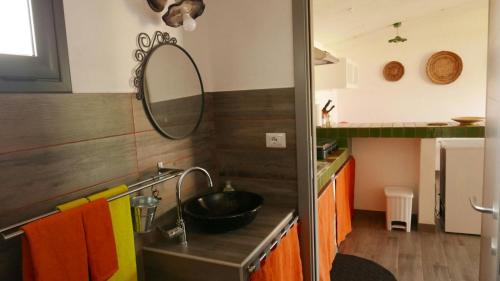 a kitchen with a sink and a mirror at Naramanue in Dorgali