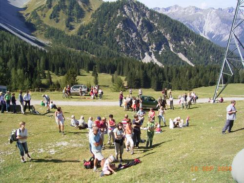 a crowd of people on a field with mountains in the background at Haus Panorama in Lermoos