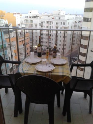 a table with two bottles of wine on a balcony at Carol Beach House in Armação de Pêra