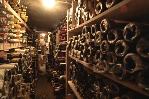 a room filled with shelves filled with wine bottles at Hotel Tosco Romagnolo in Bagno di Romagna