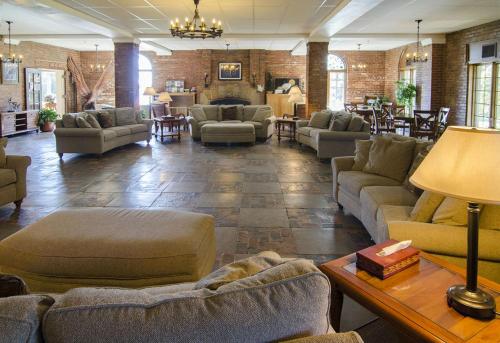 a large living room with couches and tables at Potawatomi Inn & Cabins in Angola