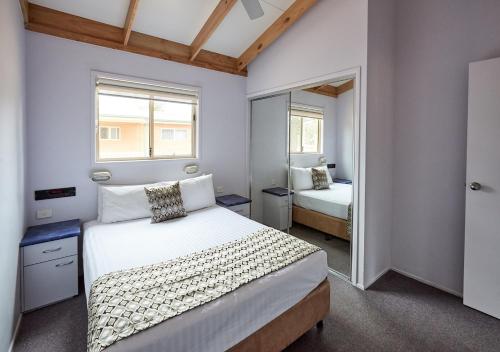 
A bed or beds in a room at Norah Head Holiday Park
