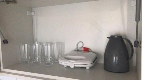 a kitchen counter with a blender and glasses on it at Residence Iloa Resort in Barra de São Miguel