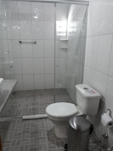 a bathroom with a toilet and a trash can at Hotel Americas in Fortaleza