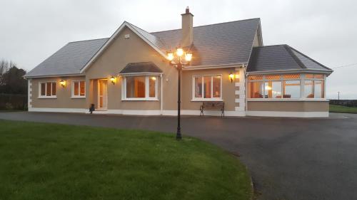a house with a street light in front of it at Large Luxury House in Ballyell