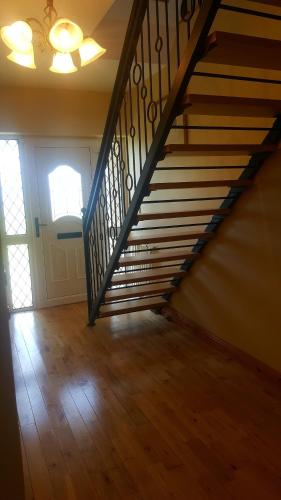 an empty room with a staircase in a house at Large Luxury House in Ballyell