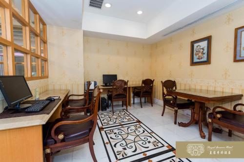 a waiting room with desks and chairs and a computer at Royal Seasons Hotel Taipei ‧ Nanjing W. in Taipei