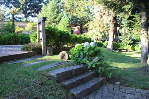 a set of stone steps in a garden with flowers at Pousada São Chico Eco Village in São Francisco de Paula