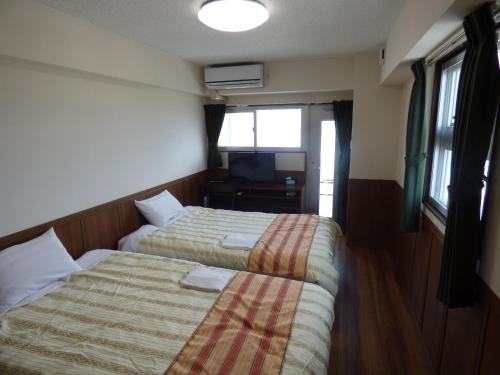 Ένα ή περισσότερα κρεβάτια σε δωμάτιο στο Hotel Peacely In Miyakojima Nexus