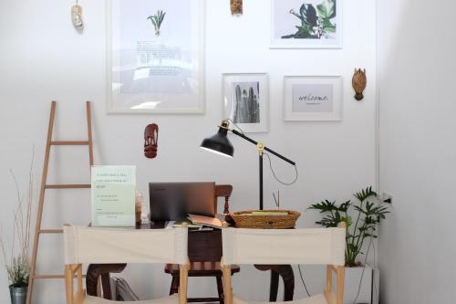 a room with a desk with a computer and two chairs at Haus Sathorn 21 Bed and Breakfast in Bangkok