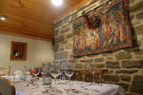 a dining room with a table with wine glasses at Amy's House Bed & Breakfast in Auburn