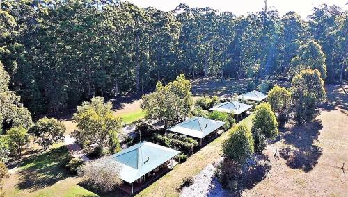 an overhead view of a house with roofs and trees at Treenbrook Cottages in Pemberton