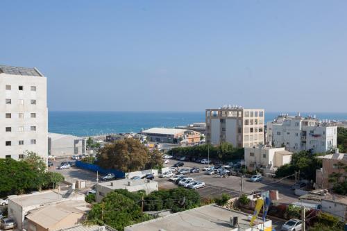 an aerial view of a city with a parking lot at Armon Hayarkon Hotel in Tel Aviv