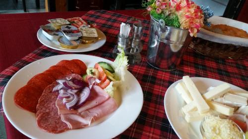 a table with three plates of food on a table at Báró Eötvös Loránd Menedékház in Pilisszentkereszt