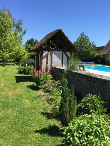 a garden with a gazebo next to a pool at Maison In Normandie in Saint-Pierre-la-Garenne