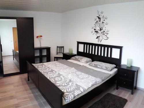 a bedroom with a large bed in a room at Ferienwohnung Seibt in Plettenberg