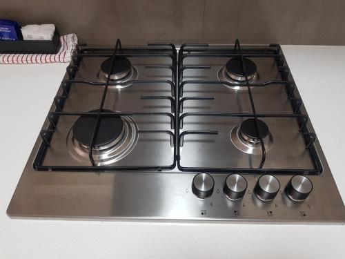 a stove top with four burners on top of it at City Waters in Perth