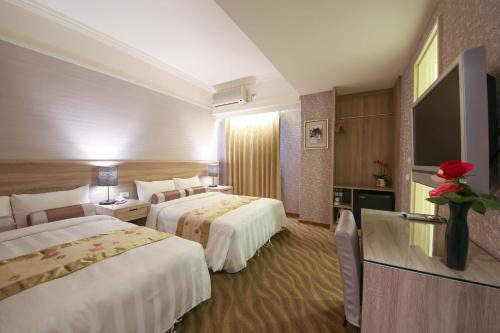 En eller flere senge i et værelse på Unique Hotel
