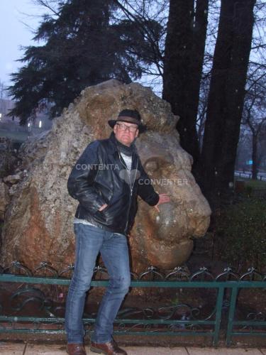 a man standing in front of a large rock at Ferme D"Hote Lala Fatima in Aïn Leuh