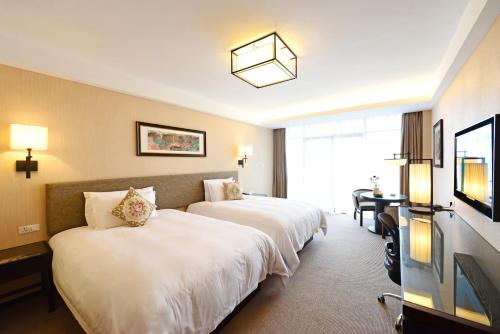 Postel nebo postele na pokoji v ubytování SSAW Boutique Hotel Hangzhou Qiandao Lake
