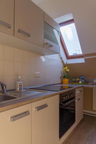 a kitchen with a stove and a sink and a window at Apartment Widey Str. 52 in Witten