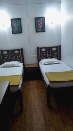 a room with two beds in a room at Carlton Hotel Mumbai - Behind Taj Mahal Palace Colaba Mumbai in Mumbai