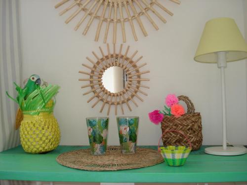 a table with vases and a mirror and a lamp at La Clorinde in Moustiers-Sainte-Marie