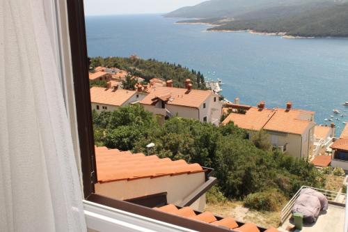 a view from a window of a town and the water at Apartments Mareblu in Rabac