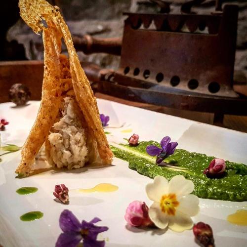 a plate of food with rice and flowers on it at Agriturismo Treterre in Pianello Del Lario