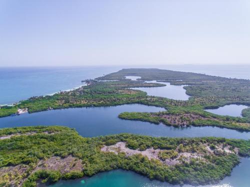 an aerial view of a group of islands in the water at Tintipan Cabana SalSiPuedes in Tintipan Island