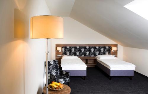 A bed or beds in a room at Bodrogi Kúria Wellness Hotel