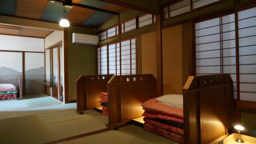 Postel nebo postele na pokoji v ubytování Japanese Guesthouse Kinosaki Wakayo (Female Only)