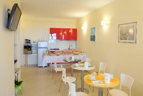 a kitchen with two tables and chairs in a room at La Perla Del Conero Affittacamere in Numana