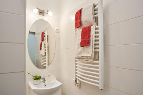 Un baño blanco con lavabo y espejo. en CLAUDIA Apartments Budapest, en Budapest