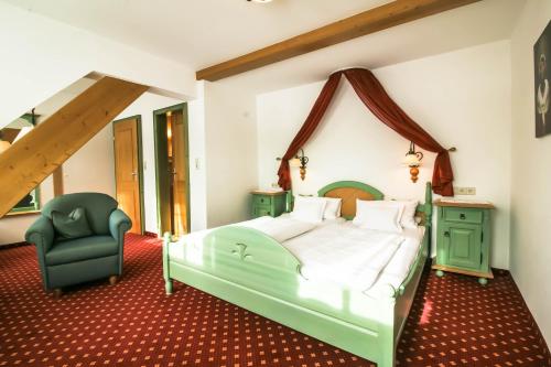 a bedroom with a green bed and a green chair at Gasthaus Zum Kreuz in Sankt Märgen