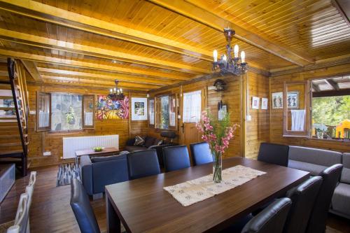a dining room with a table and chairs at Ricky Chalet Near Troodos in Spilia