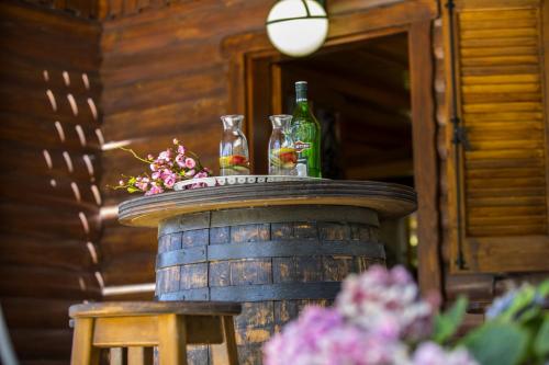 a table with two bottles and glasses on top of a barrel at Ricky Chalet Near Troodos in Spilia