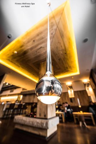 a spoon hanging from the ceiling of a restaurant at Hotel Montana in Guxhagen