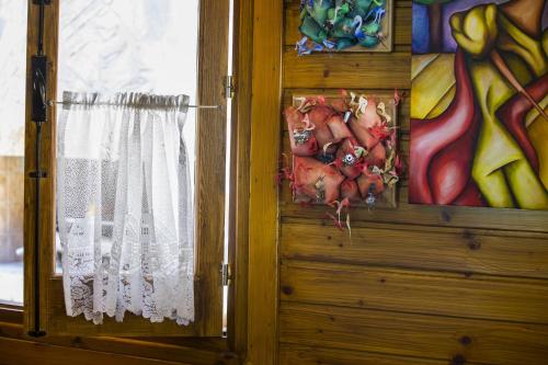 a door with a curtain and a painting on the wall at Ricky Chalet Near Troodos in Spilia