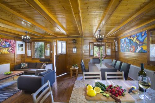 a living room with a table with fruit on it at Ricky Chalet Near Troodos in Spilia
