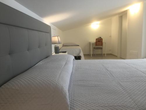 a bedroom with a large white bed in a room at Linda's B&B in Ragusa