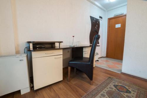 an office with a desk and a chair in a room at Hotel Filipov in Kochani