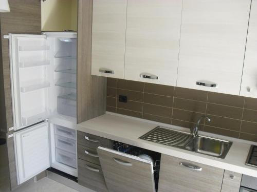 a kitchen with white cabinets and a sink at La Casa del Mare in Sperlonga