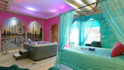 a bedroom with a bed and a tub in a room at La Ferme Briarde in Couperdrix