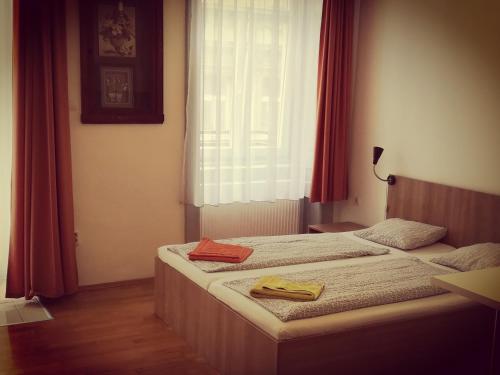a bedroom with a bed and a window at Capital Guesthouse Budapest in Budapest