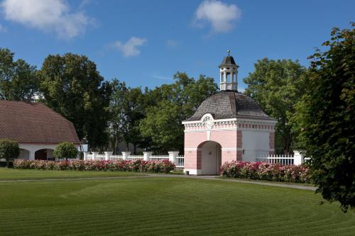 a gazebo with a clock tower in a park at Sagadi Manor Hotel in Sagadi