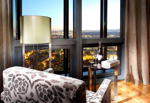 a living room with a couch and a large window at Eurostars Madrid Tower in Madrid