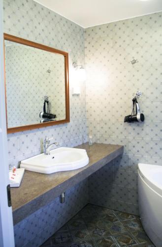 a bathroom with a sink and a mirror at Sagadi Manor Hotel in Sagadi